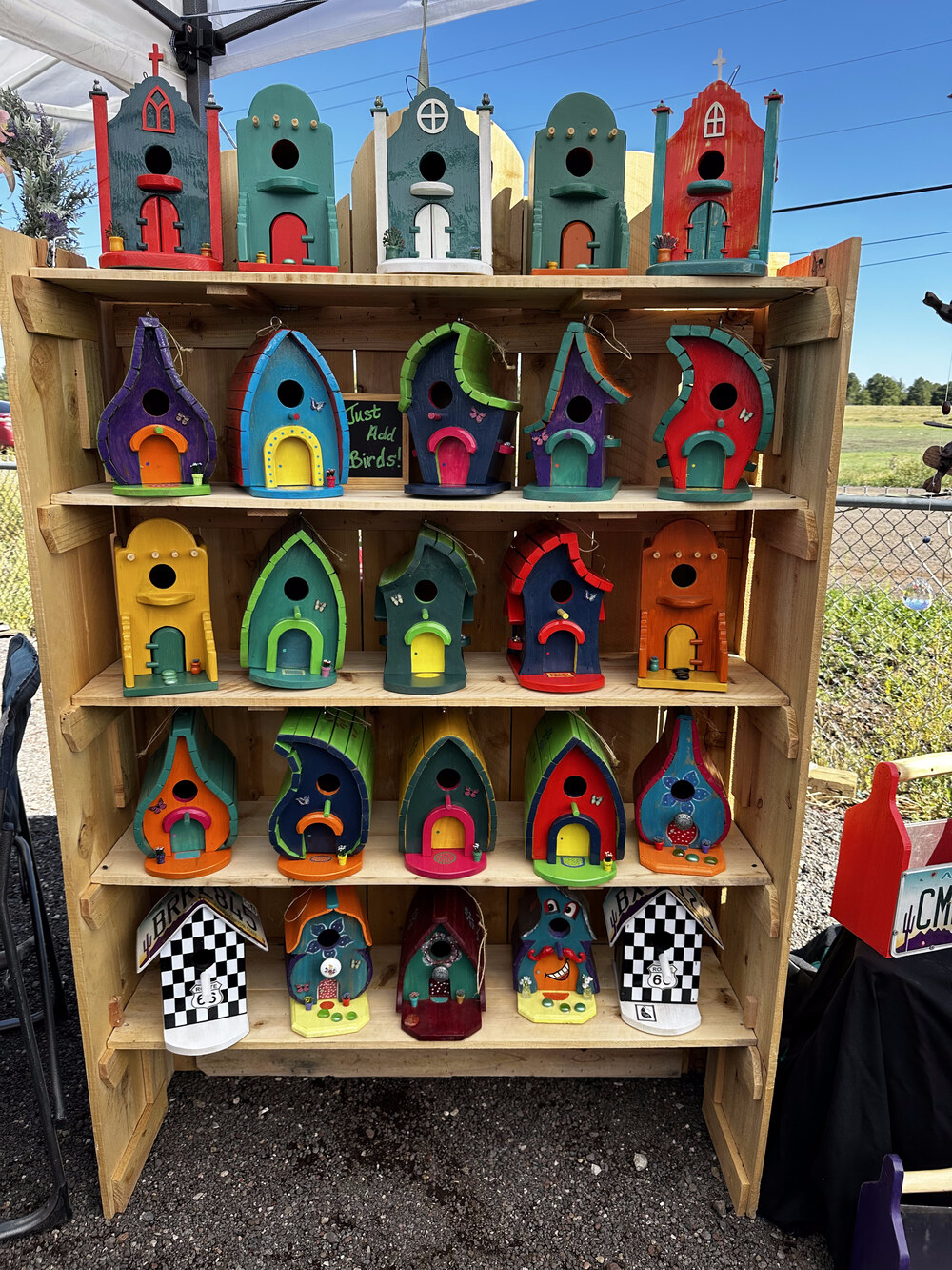 Nurture Your Joy birdhouses on display at a craft show